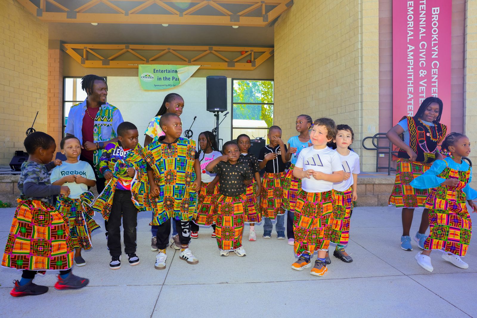 Young dancers in custom kente-print skirts and tops lined up for the performance