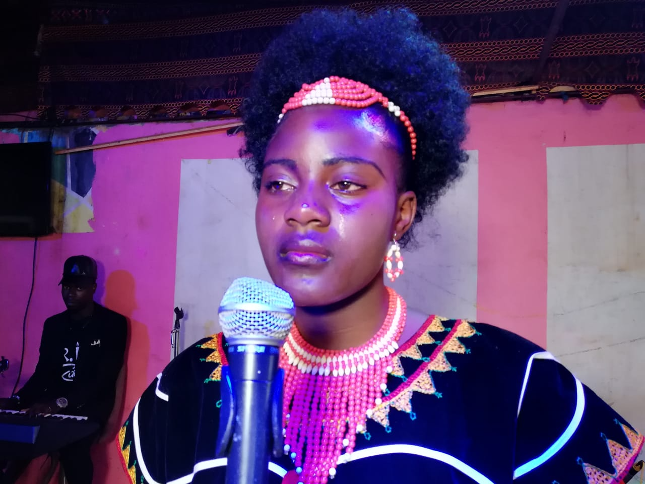 Angel Akong performing live in traditional dress