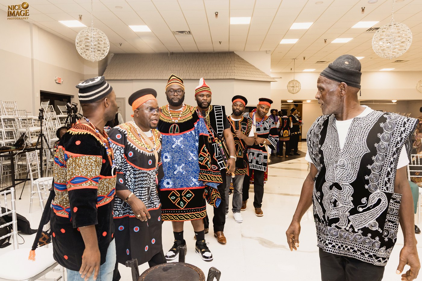 Kom community members greeting an elder during the Thursday ceremony