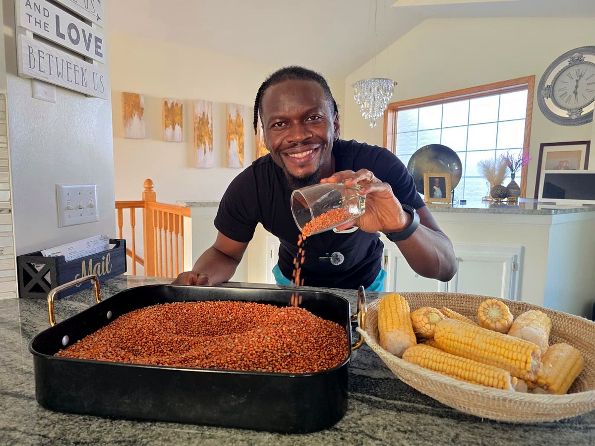 Guinea corn being poured beside a basket of maize